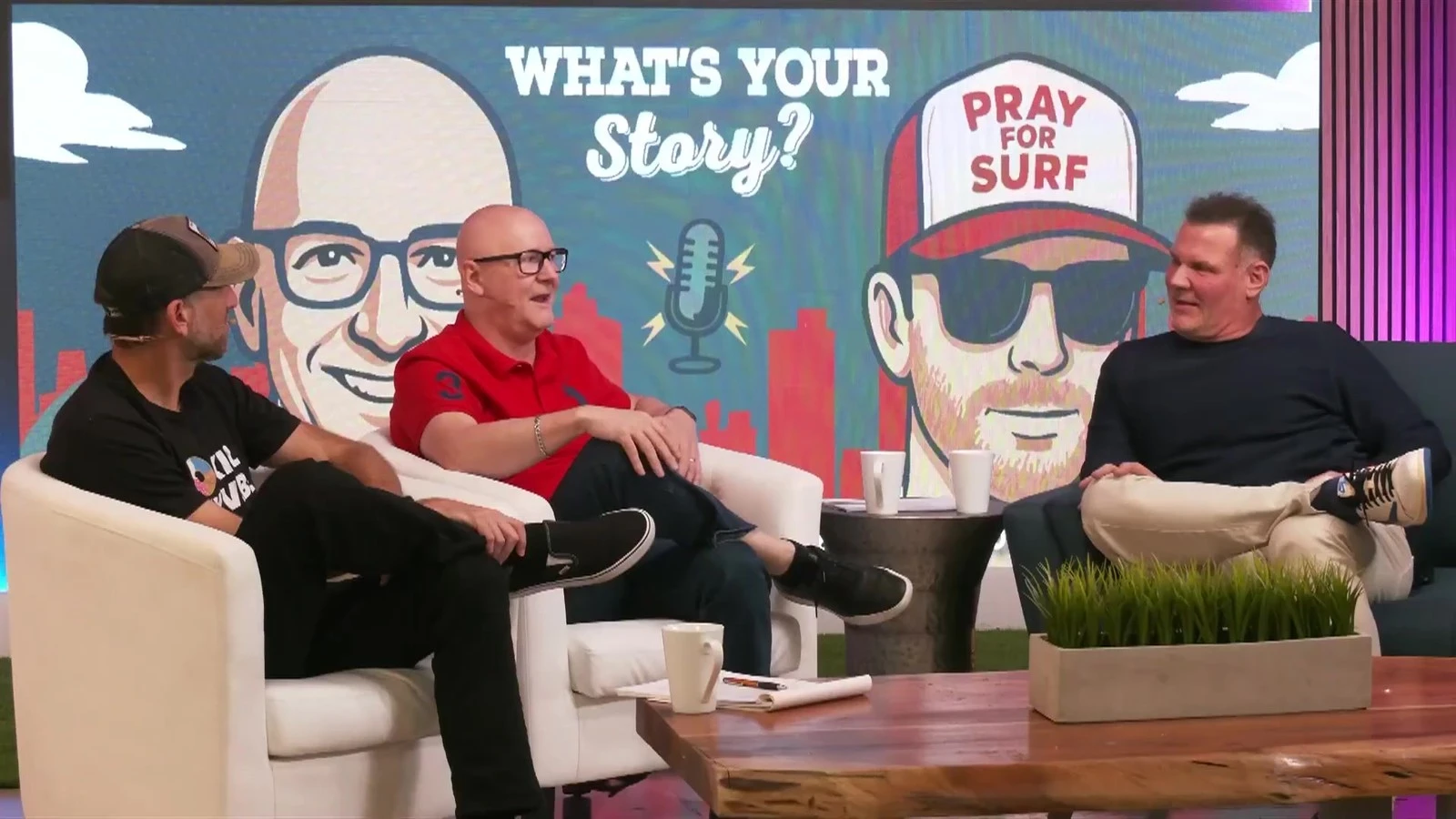 Podcast hosts and a guest in conversation on a talk show set with a custom video wall at EventLab Studios®